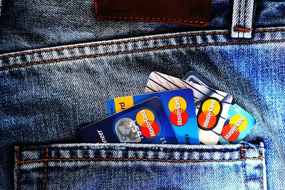 Capital One Credit Card Application concept with multiple credit cards in jeans pocket